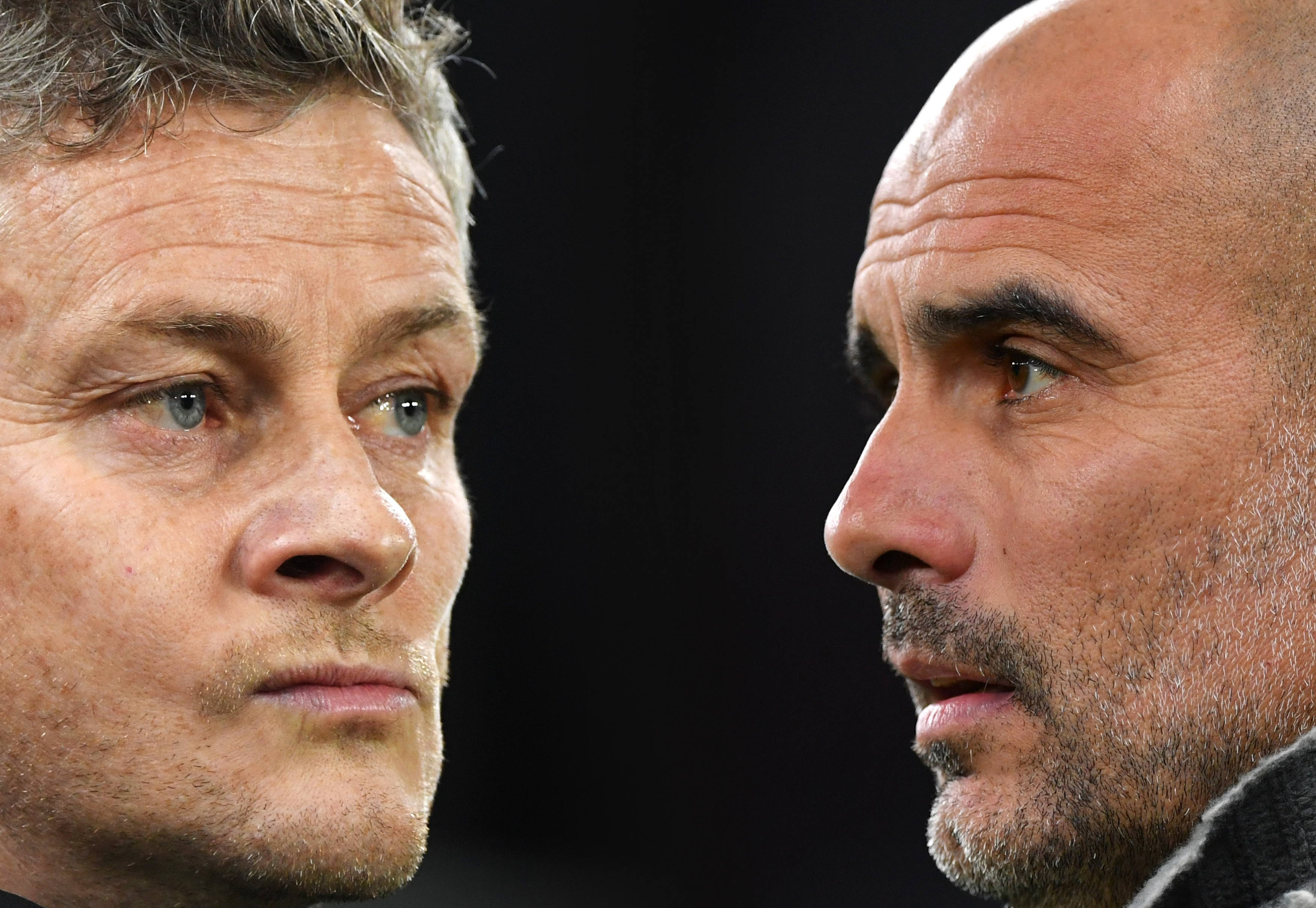 FILE PHOTO (EDITORS NOTE: COMPOSITE OF IMAGES - Image numbers 1074604018,1141519827 - GRADIENT ADDED) In this composite image a comparison has been made between Ole Gunnar Solskjaer, Manager of Manchester United (L) and Josep Guardiola, Manager of Manchester City. Manchester United and Manchester City meet in a Premier League fixture on April, 24, 2019 at Old Trafford in Manchester. ***LEFT IMAGE*** CARDIFF, WALES - DECEMBER 22: Ole Gunnar Solskjaer, Interim Manager of Manchester United looks on before the Premier League match between Cardiff City and Manchester United at Cardiff City Stadium on December 22, 2018 in Cardiff, United Kingdom. (Photo by Stu Forster/Getty Images) ***RIGHT IMAGE*** LONDON, ENGLAND - APRIL 09: Josep Guardiola, Manager of Manchester City looks on prior to the UEFA Champions League Quarter Final first leg match between Tottenham Hotspur and Manchester City at Tottenham Hotspur Stadium on April 09, 2019 in London, England. (Photo by Dan Mullan/Getty Images)
