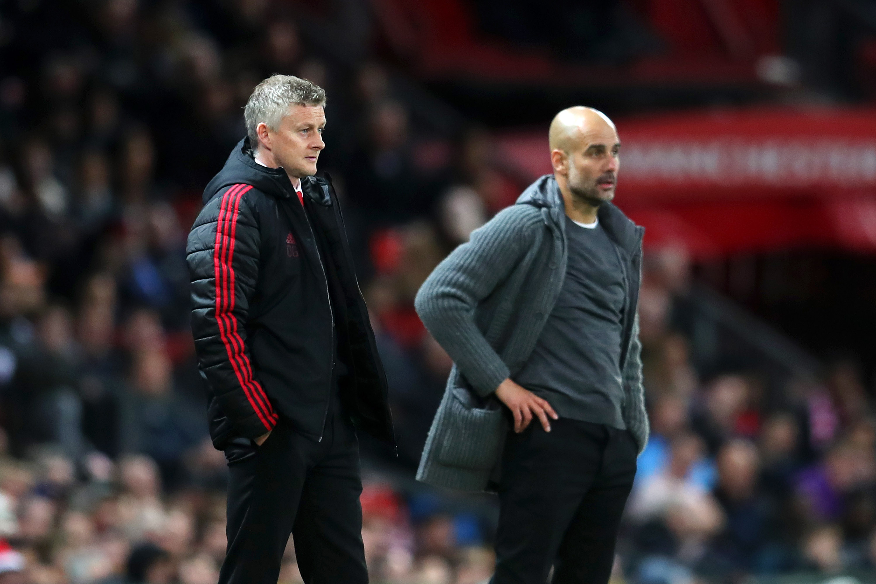 MANCHESTER, ENGLAND - APRIL 24: Ole Gunnar Solskjaer, Manager of Manchester United and Josep Guardiola, Manager of Manchester City look on during the Premier League match between Manchester United and Manchester City at Old Trafford on April 24, 2019 in Manchester, United Kingdom. (Photo by Catherine Ivill/Getty Images)
