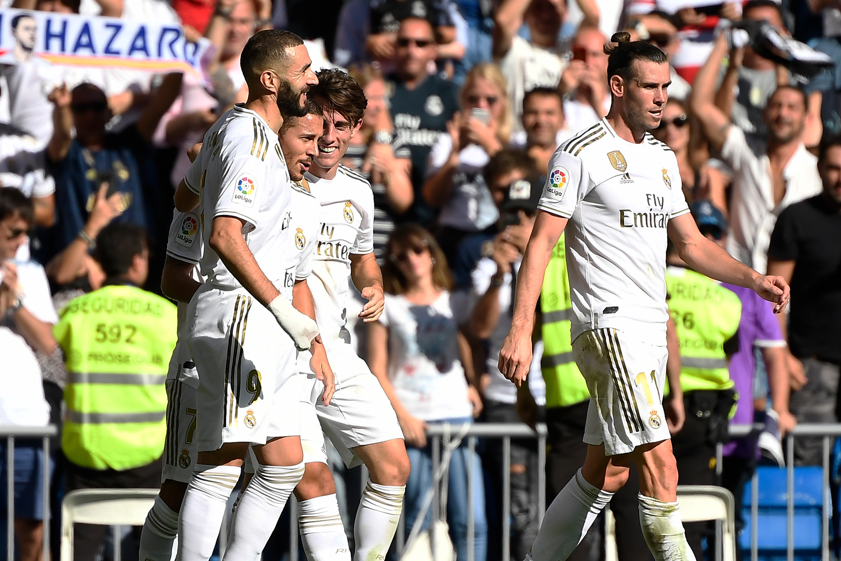 Real Madrid's Belgian forward Eden Hazard (2L) celebrates with teammates scoring his team's second goal during the Spanish league football match between Real Madrid CF and Granada FC at the Santiago Bernabeu stadium in Madrid on October 5, 2019. (Photo by PIERRE-PHILIPPE MARCOU / AFP) (Photo by PIERRE-PHILIPPE MARCOU/AFP via Getty Images)
